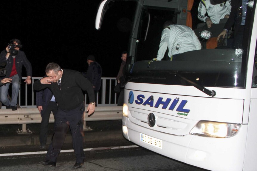 Fenerbahce soccer team bus driver holds head after shooting