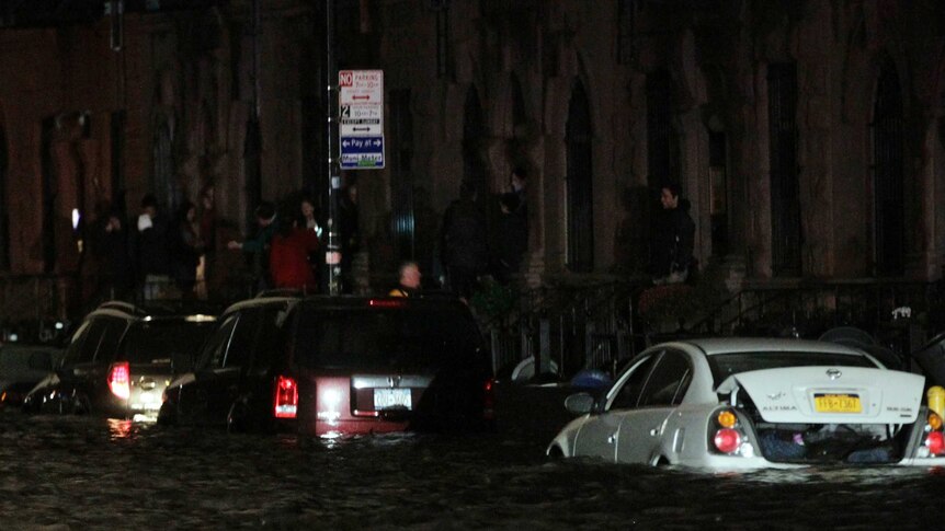 Flood waters brought on by Hurricane Sandy over run cars in New York's lower east side
