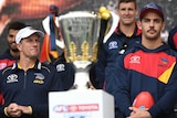 Don Pyke and Taylor Walker look at the AFL premiership cup.