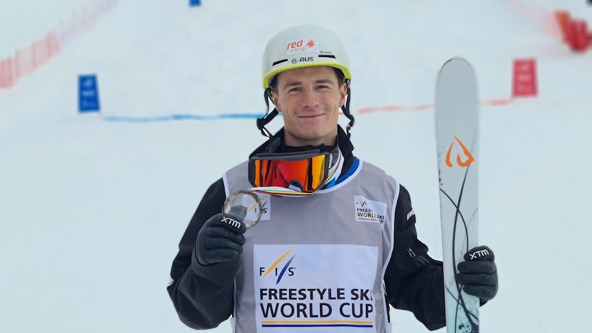 Matt Graham holds up a medal