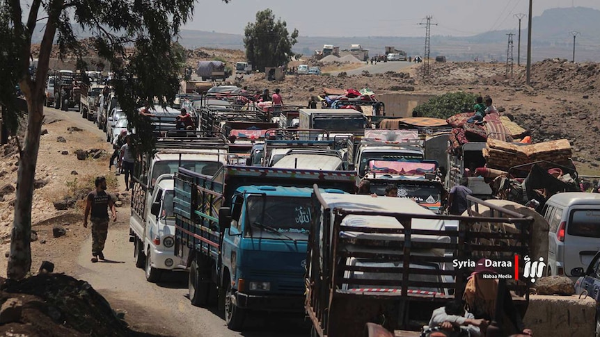 A long line of people in their vehicles fleeing from Daraa block the roads