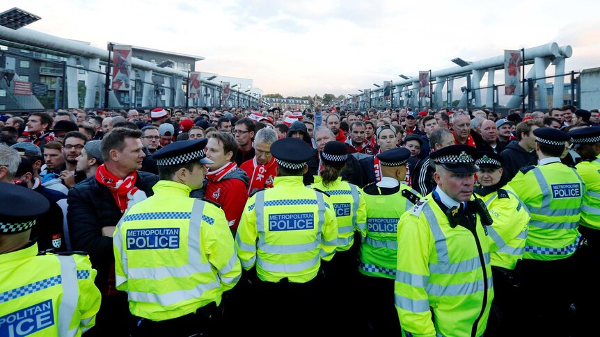 Police hold off FC Koln fans at Emirates Stadium