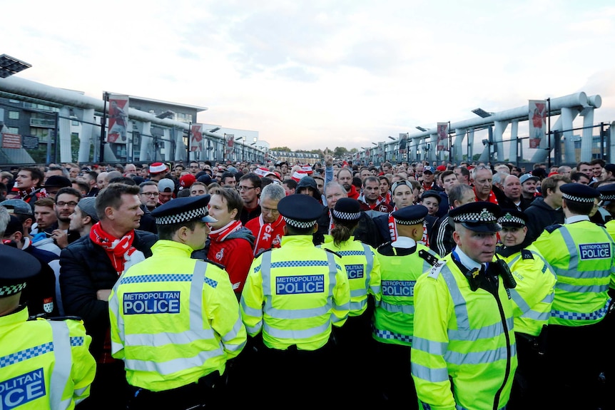 Police hold off FC Koln fans at Emirates Stadium