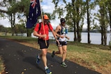 Two of the competitors in the Anzac Ultra Marathon enjoy the view of Lake Burley Griffin on their run.