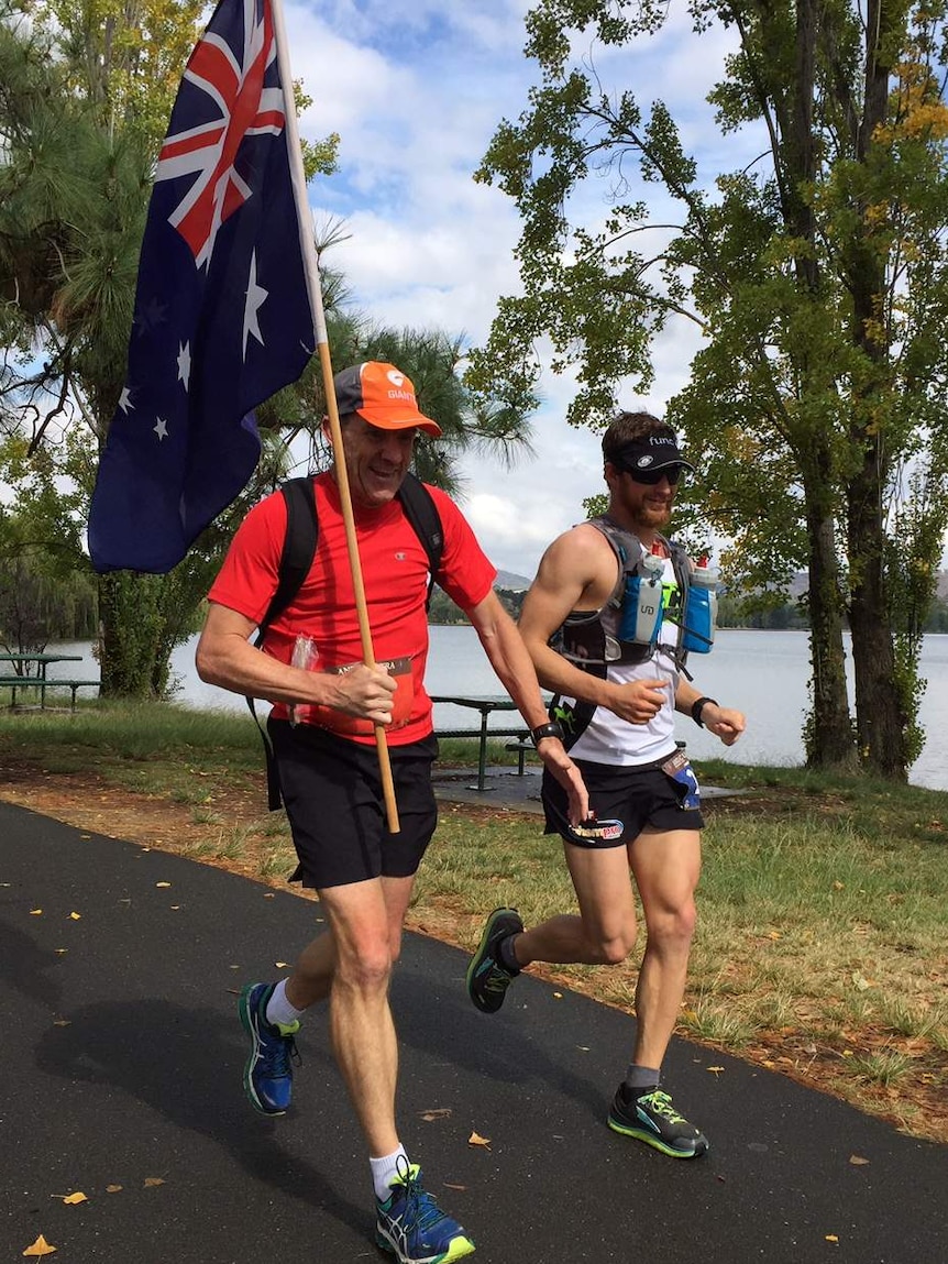 Two of the competitors in the Anzac Ultra Marathon enjoy the view of Lake Burley Griffin on their run.