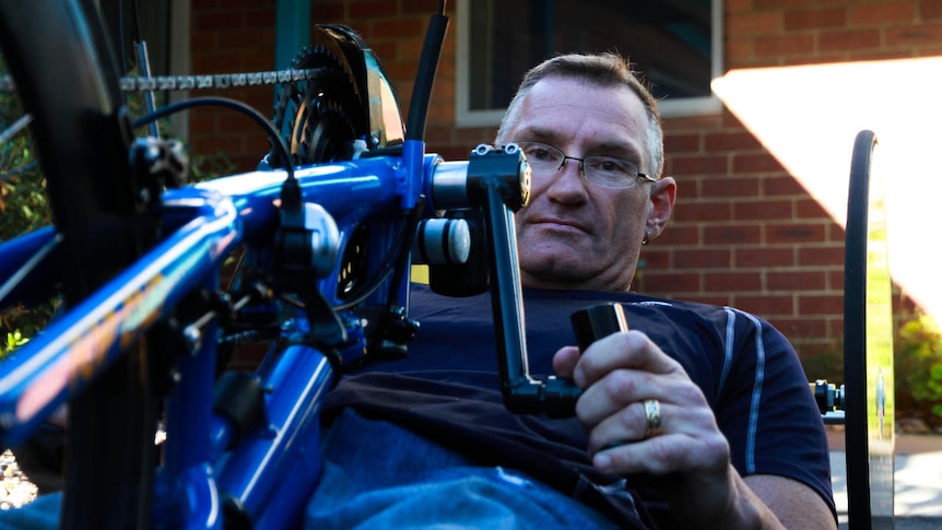 Michael Taylor, in 2013, is barely an inch above the ground when riding his hand-cycle.