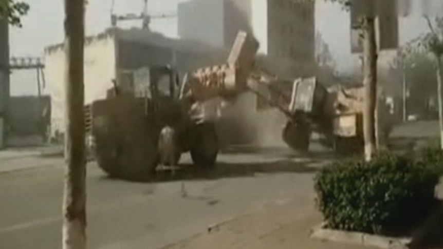 Bulldozers battle on China's streets