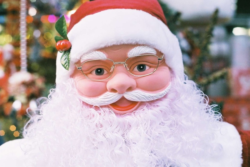 A model of Santa smiles at the camera