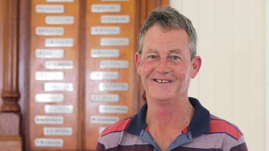 Raymond Harvey from Maroon in Queensland's Scenic Rim region stands in front of the town's honour board.