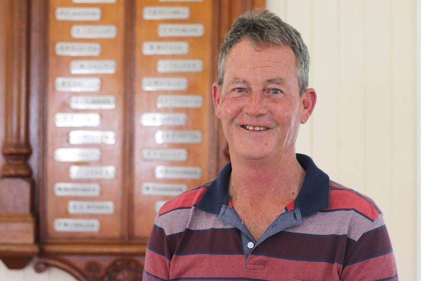 Raymond Harvey from Maroon in Queensland's Scenic Rim region stands in front of the town's honour board.