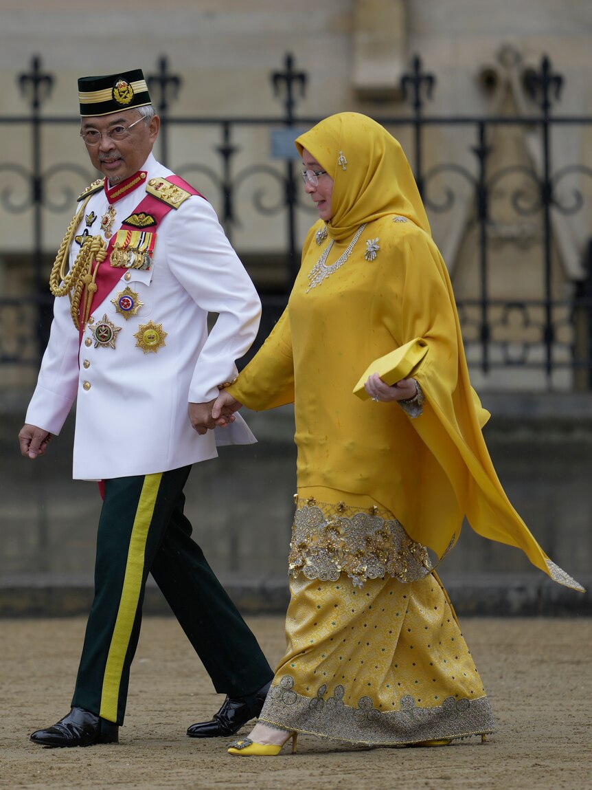 A man and woman walking hand-in-hand