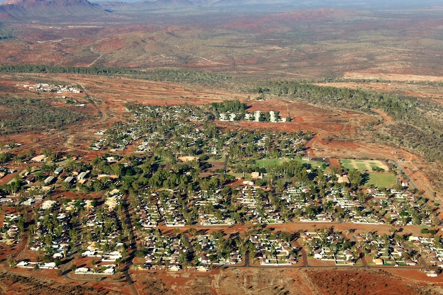 An aerial view of a town with red earth.