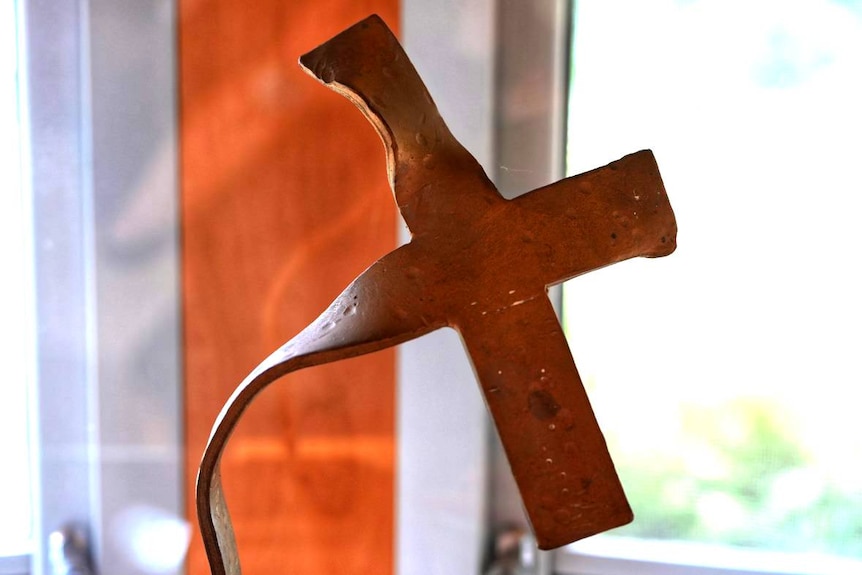 A twisted, melted metal cross.