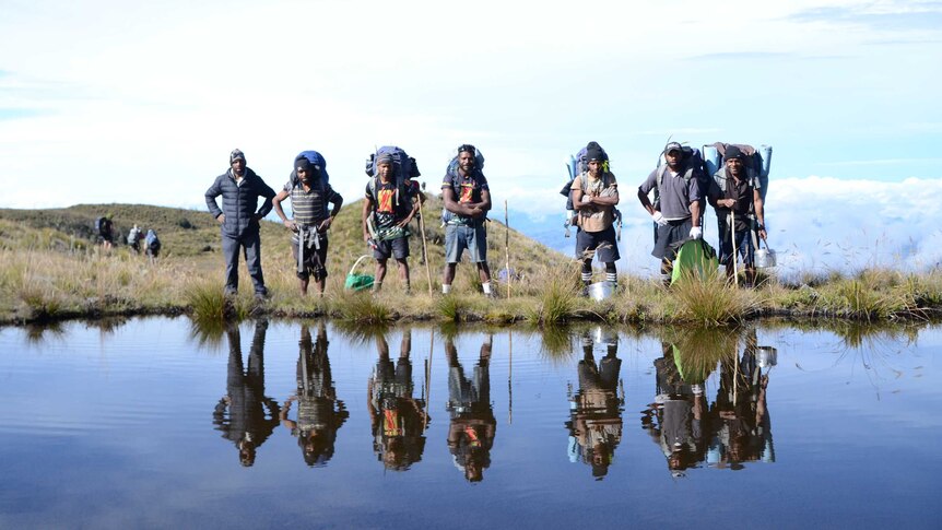 Local porters next to a lake on Mt Giluwe