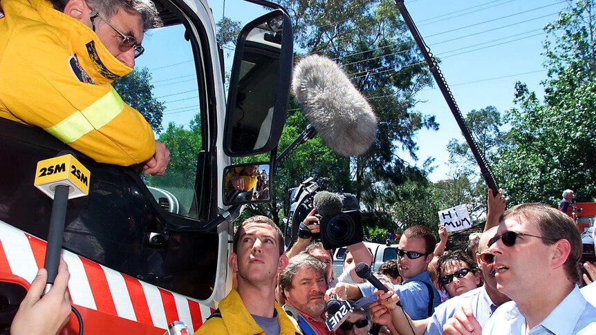 Prince Andrew, the Duke of York, talks to firefighters in Warrimoo in the Blue Mountains.