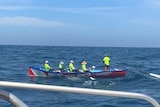5 men in a surfboat at sea