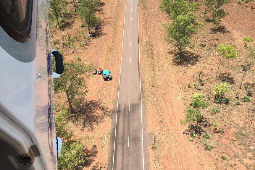 An aerial view of a Careflight aircraft scoping out the scene of a motor vehicle accident on a highway.
