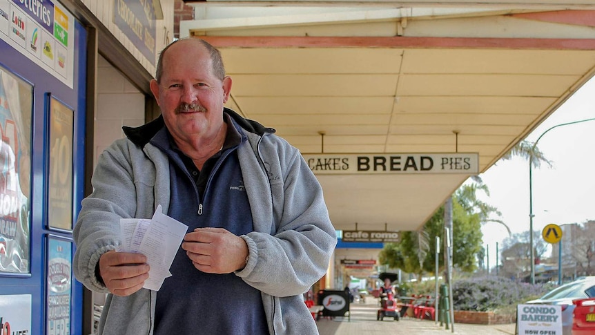 Condobolin Chamber of Commerce President, Mick Hanlon, displays receipts from products sold locally