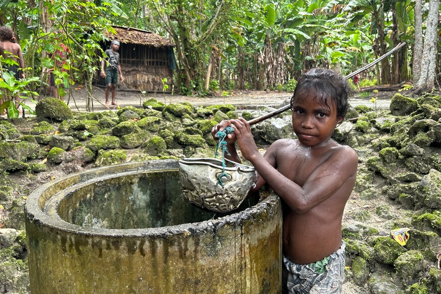 A young boy at a well 