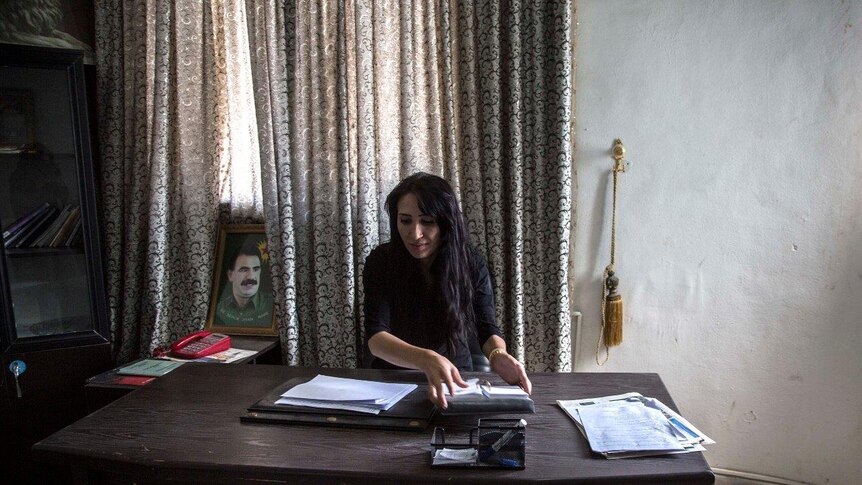 Brevan Hassan, the co-president of Kobani Canton in Syrian Kurdistan sits in her office