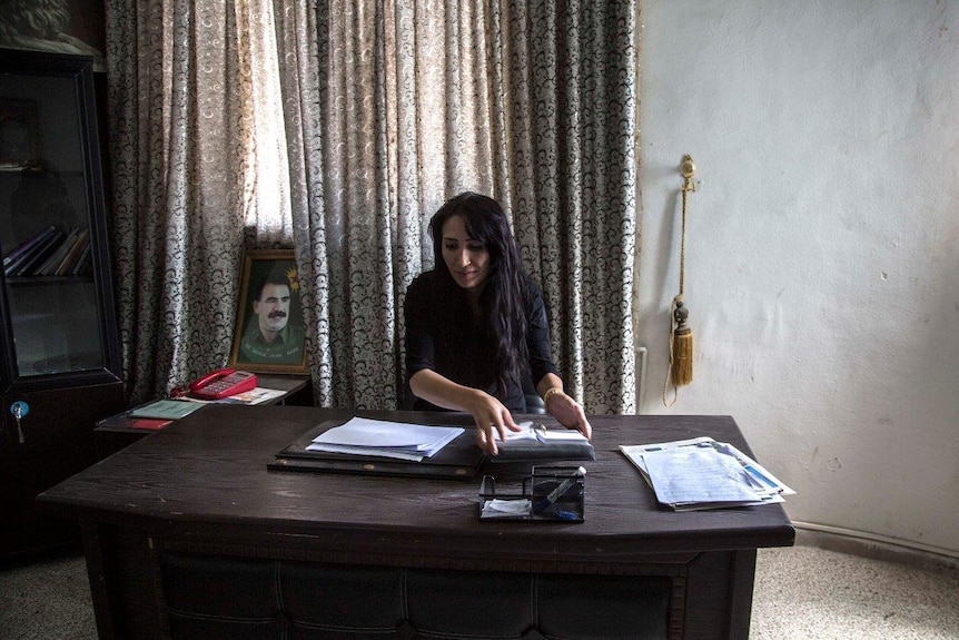 Brevan Hassan, the co-president of Kobani Canton in Syrian Kurdistan sits in her office