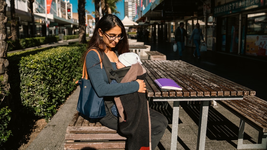 a young woman looking at her baby