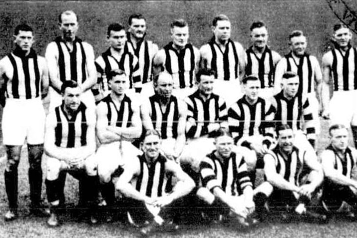 A black and white photo of a team of 1930s footballers, they are wearing striped jerseys.