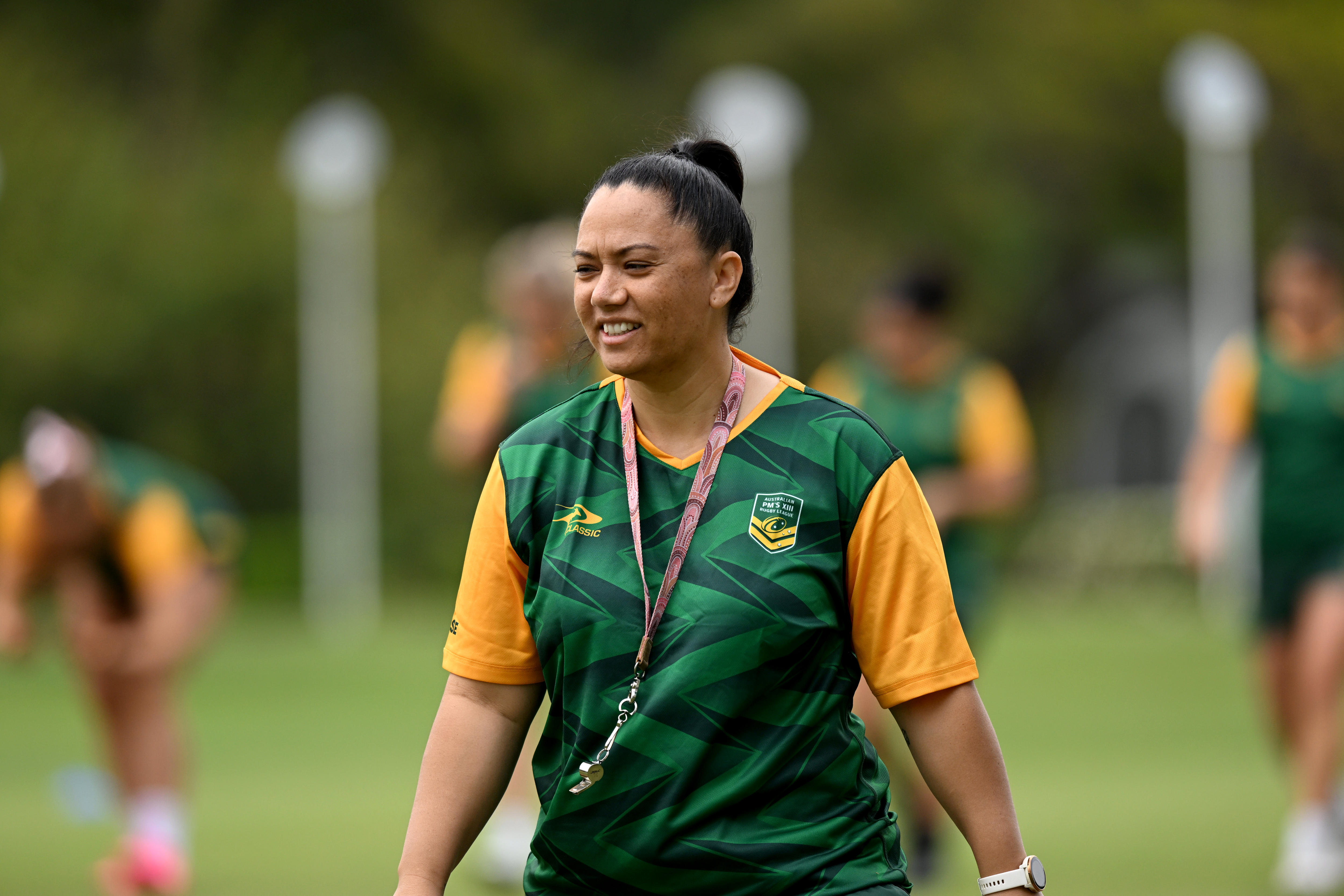 A woman wearing a whistle attends training