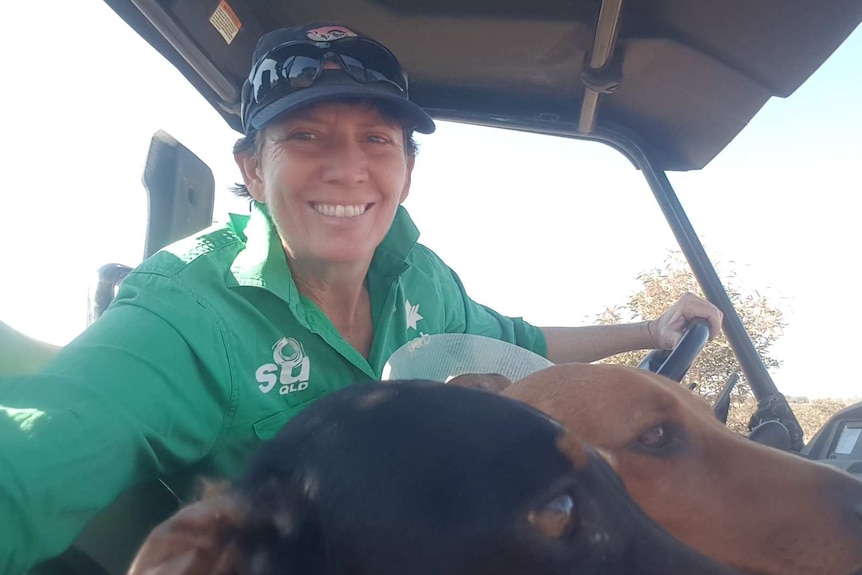 Trina Patterson takes a selfie in a truck with her two dogs.