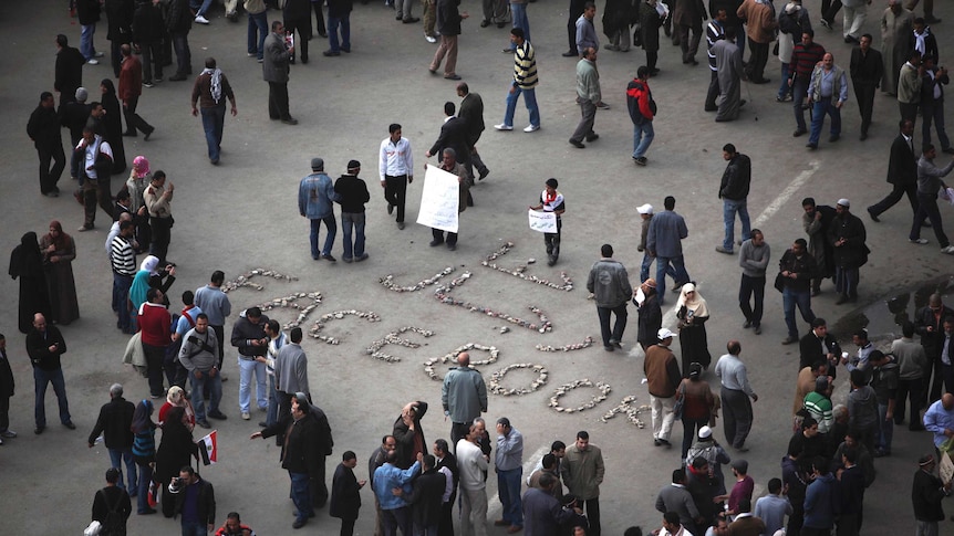 We are the men of Facebook" is written on the ground as anti-government protesters gather in Tahrir Square.