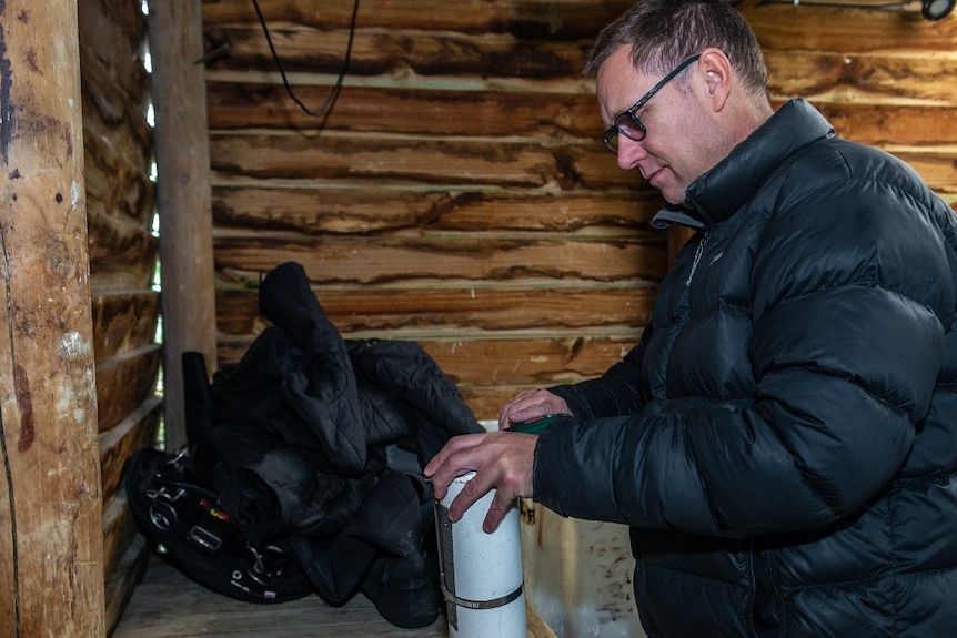 A cave diving expert preparing diving equipment.