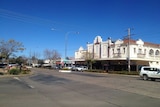 The main drag of a small country town beneath a deep blue sky.