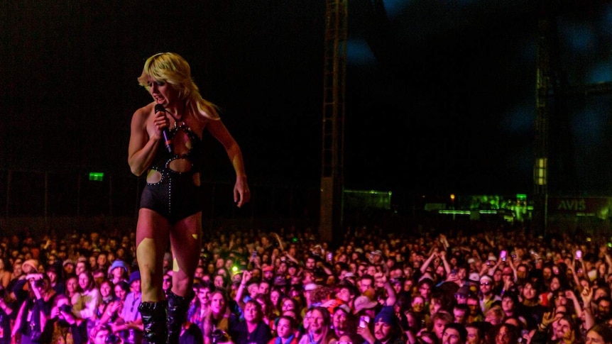 Amy Taylor stands on stage above thousands at Splendour In The Grass