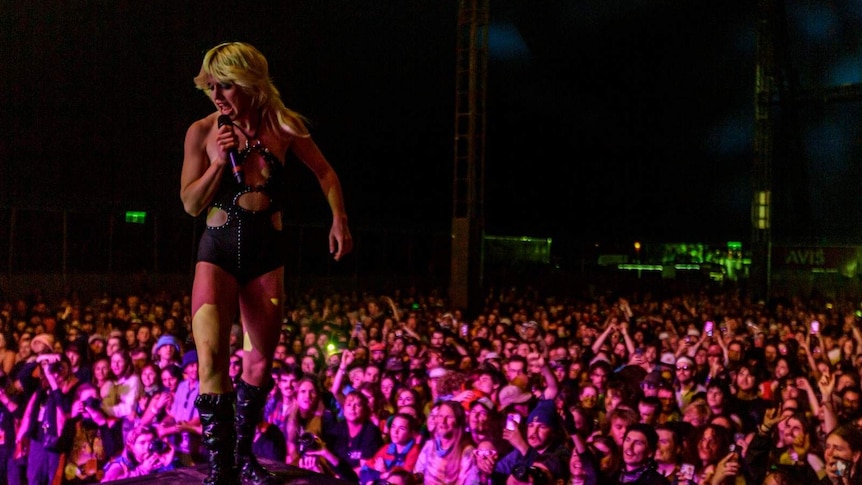 Amy Taylor stands on stage above thousands at Splendour In The Grass