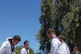 The burial party lower the coffin of the unknown sailor from HMAS Sydney