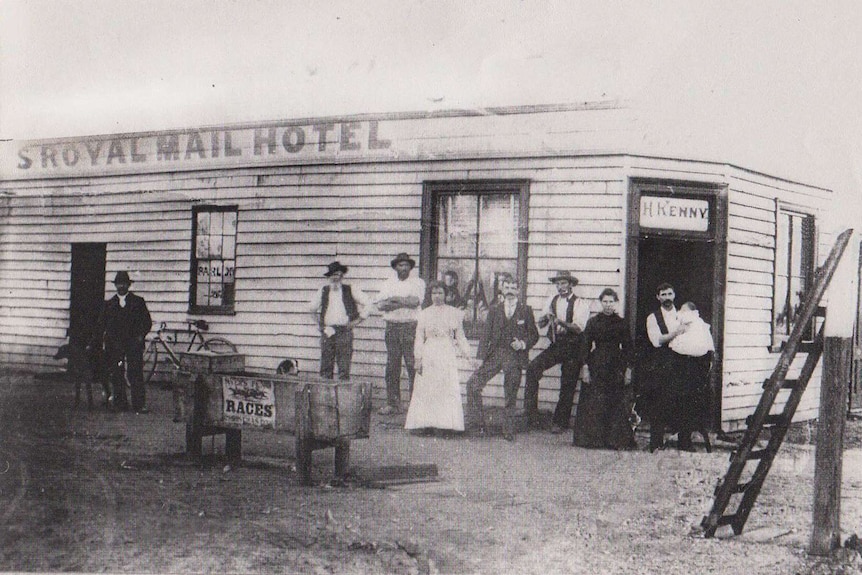 Black and white photograph of a building saying Royal Mail Hotel with people out the front in old fashioned clothes