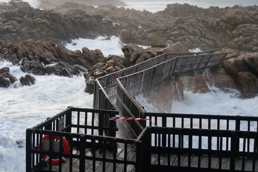 A damaged bridge spanning a section the ocean at Canal Rocks