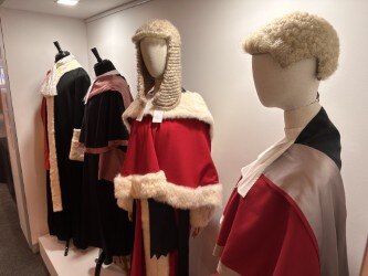 Portraits of judges, wigs and documents inside court