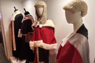 Portraits of judges, wigs and documents inside court