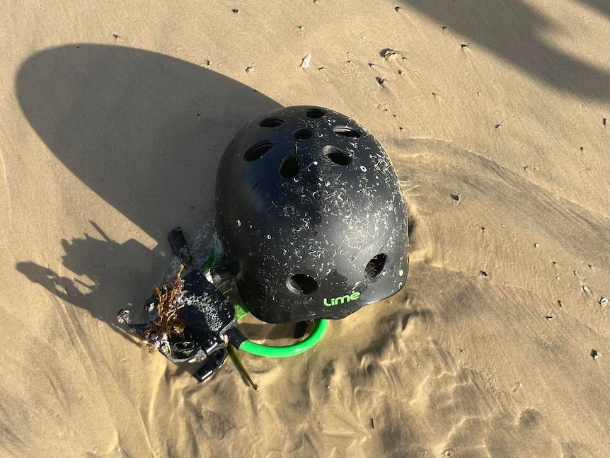 Lime scooter helmet on beach