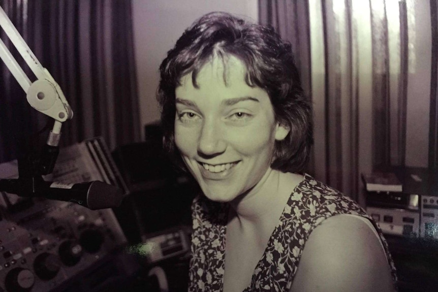 A young woman in an old radio studio.