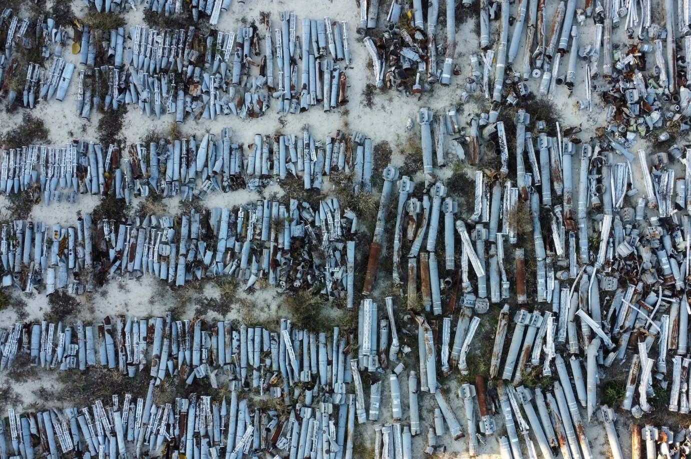Rows of missile shells lie on the ground