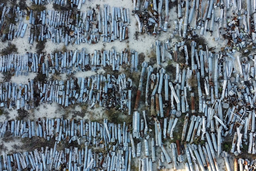 Rows of missile shells lie on the ground