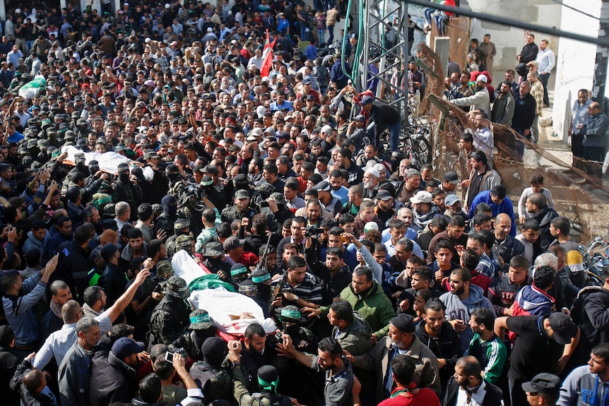 Palestinian mourners carry the bodies of Hamas militants who were killed in an Israeli raid.