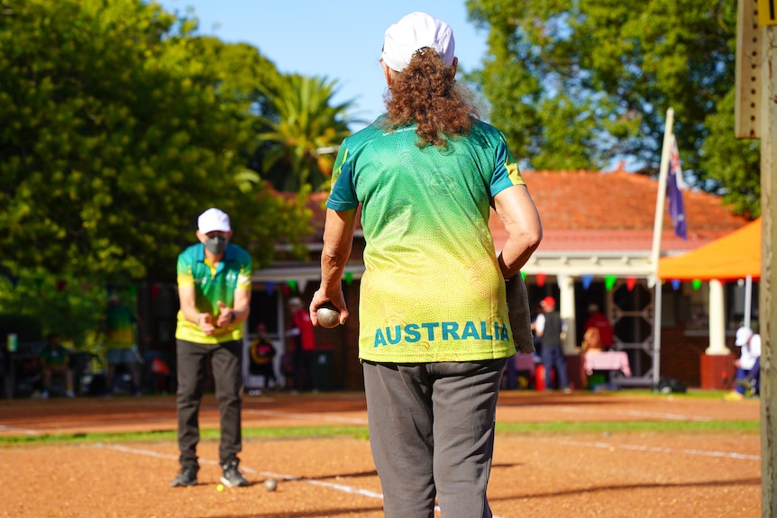 Lynette pictured from behind playing petanque