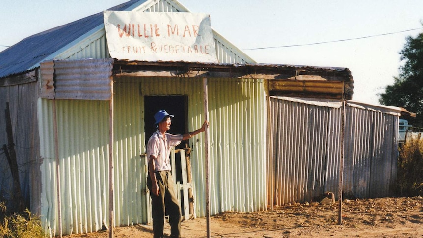 Willie Mar Junior in front of the outback shop and market garden in the 1990s in Winton in Queensland's central-west