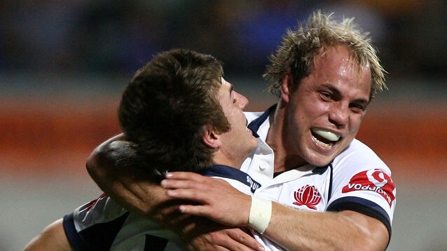 Phil Waugh (R) of the Waratahs celebrates a try with Rob Horne