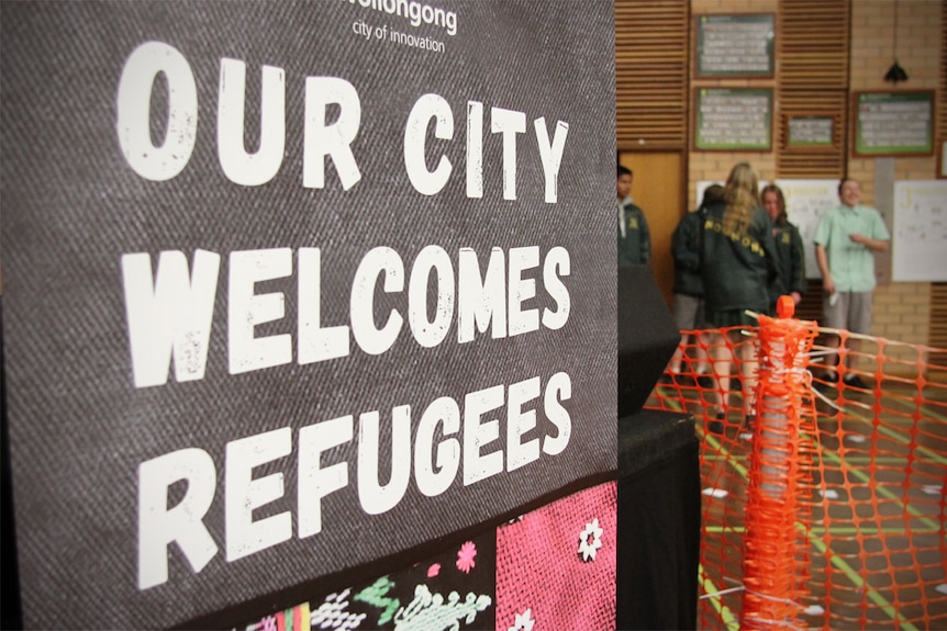 A sign that says 'Our city welcomes refugees'