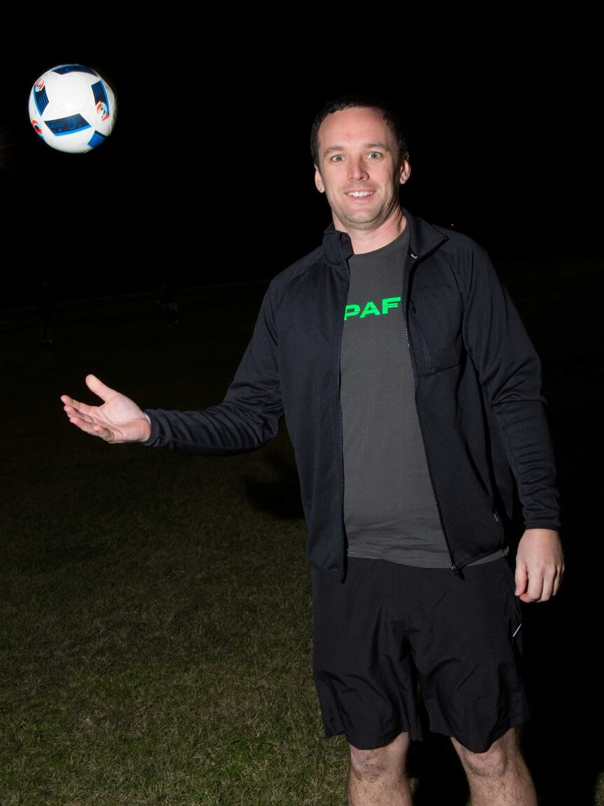 Murray Phillips throws a ball into the air.