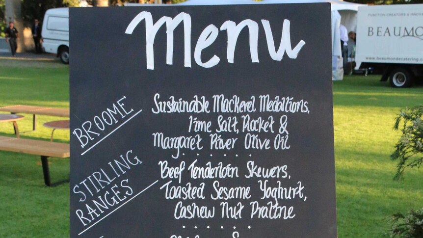 Chalk menu board at Prince Charles' birthday party featuring local produce.